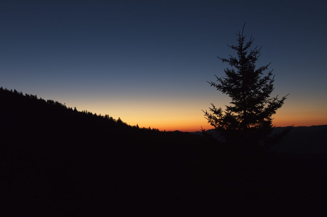 Twilight blue hour with distant ridges fading into evening
