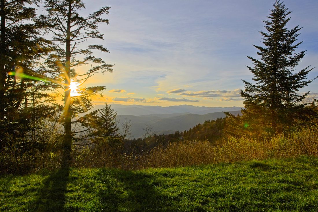 Warm sunset light raking across a wooded Appalachian ridge