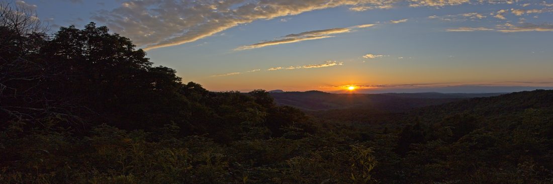 Wide panoramic sunset over the layered Blue Ridge Mountains